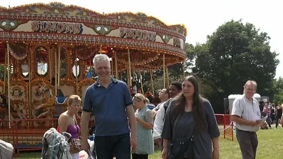 A vintage carousel and visitors at a past People's Day in Lewisham